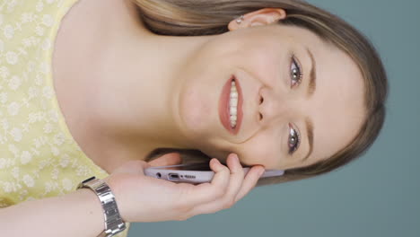Vertical-video-of-Happy-talking-woman-on-the-phone.